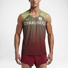 a man in red shorts and a green tank top with the words gyakisou on it