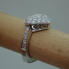 "This pave diamond heart shape ring is hand made in 18k white gold. There are 36 Pave set side diamonds totaling .76Cts, approximately 3/4 Carat The diamonds are VS clarity and G color range. We make all our own jewelry and focus on quality and durability. The ring is currently a size 6.25 you will be able to return it within the listed time frame for any reason at all. It will take 1-2 business days processing time. We can size it any size from 5 to 7 but it would be a FINAL SALE. It will take Wedding Heart Ring With Hallmarked Diamond, Diamond Heart Cut Ring Hallmarked, Luxury Pave Setting Heart Ring For Anniversary, Diamond White Heart Ring With Pave Setting For Anniversary, Heart Cut Diamond Ring With Pave Setting For Anniversary, Heart Cut Rings With Pave Setting For Gift, Hallmarked Heart-shaped Diamond Ring For Anniversary, Heart-shaped Platinum Ring As Gift, Platinum Heart Ring As A Gift