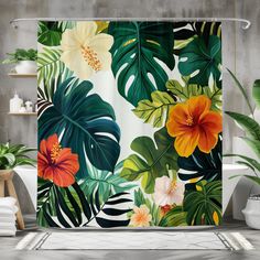 a shower curtain with tropical flowers and leaves