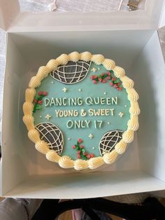 a cake in a box that says dancing queen young and sweet only 17