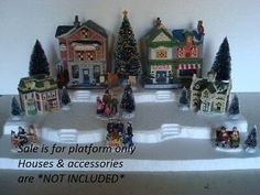 a group of christmas village figurines sitting on top of a table