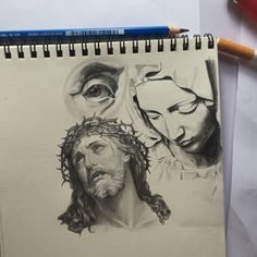 a drawing of jesus and mary with pencils next to it on top of a piece of paper