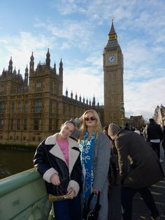 two women standing in front of the big ben clock tower