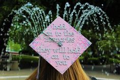 a woman wearing a pink graduation cap with the words hold on to the memories they will look on to you