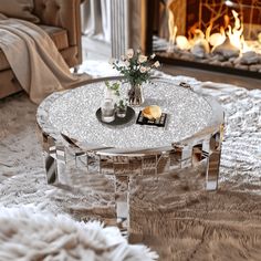 a living room with a fire place in the fireplace and a glass table on top