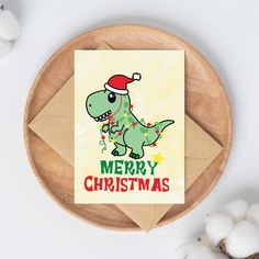 a christmas card with a cartoon dinosaur wearing a santa hat on it's head