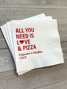 four personalized napkins with the words all you need is love and pizza printed on them