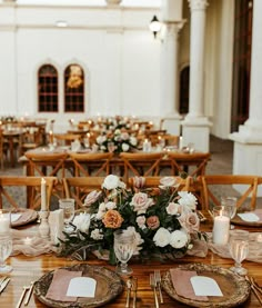 the table is set with place settings and flowers