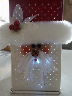 a white box with a santa claus face on it's side and lights around the top