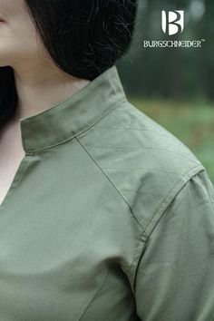 A part of our Ranger Collection, the Theresa Tunic is made from thick yet breathable cotton. Its long sleeves are reinforced with laced ribbons. These not only help open and close the sleeves around the wrists, but look elegant and chic. The shoulders are reinforced with an extra layer of fabric, making it ideal to wear with chainmail or armor without chafing. It’s also slotted at the front to allow for maximum freedom of movement. It’s a versatile piece that’s perfect for medieval fairs and LARP events. Material: 100% cotton Color: Seaweed Available Sizes: S, M, L, XL, XXL, XXXL Medieval Fair, Black Week, Fabric Making, Chain Mail, Freedom Of Movement, Larp, Long Sleeves, Festival, Long Sleeve