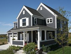 a gray house with white trim and windows