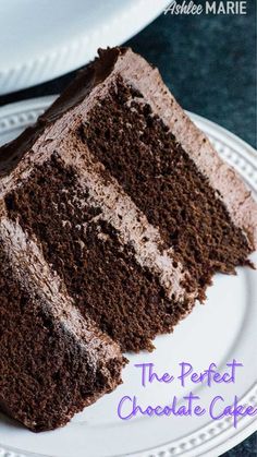 a slice of chocolate cake sitting on top of a white plate