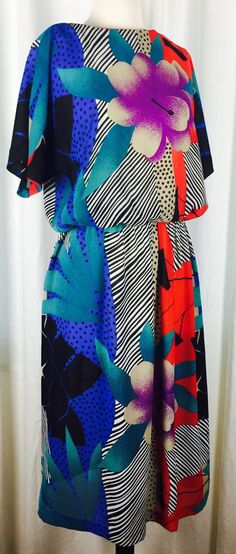 Vintage 80's bright modern abstract geometric floral print semi-sheer fabric midi length dress. Fabric is crepe-like semi sheer poly blend print.Top bodice part is lined, skirt part is not. Dress has boat neckline, Dolman short sleeves, and elasticized waist band. Looks awesome with black ankle boots or could be worn to the office with black opaque tights and chunky block heels. Made in the USA. By : Jennifer Gee. Vintage sized 14; fits modern ladies'sizes 8-12 best.  46"  total length 20.5" fla Patterned Retro Print Spring Dress, Spring Retro Print Patterned Dress, Patterned Spring Dress With Retro Print, Colorful Floral Print Midi Dress, Colorful Pattern Multicolor Midi Dress, Multicolor Abstract Print Midi Dress, Multicolor Patterned Midi Dress, Chic Multicolor Retro Print Dresses, Spring Multicolor Abstract Print Maxi Dress