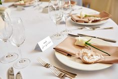 the table is set with silverware and place settings