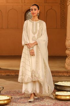 Daisy ivory silk chanderi A-line kurta with kashmiri tilla and parsi gara embroidery. Comes with palazzo and a silk organza dupatta. - Aza Fashions Parsi Embroidery Suits, Elegant Traditional Wear In Art Silk With Resham Embroidery, Elegant Traditional Wear With Resham Embroidery On Art Silk, Elegant Embroidered Art Silk Kurta, Elegant Art Silk Traditional Wear With Resham Embroidery, Elegant Traditional Art Silk Wear With Resham Embroidery, Elegant Art Silk Traditional Wear With Intricate Embroidery, Elegant Off White Raw Silk Sets, Transitional Season Wedding Unstitched Silk Suit