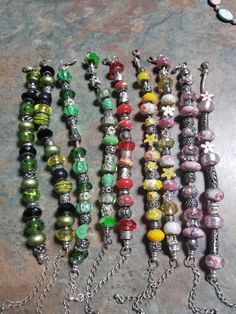 "These are large beads on a snake chain with adjustable clasp. They measure 7 3/4\" and adjust to 10\". All have antique silver and silver. Made with glass, metal and plastic beads 1) Green & Black bracelet. Green beads have black dots. 2) Yellow, Green & Black bracelet. 3) Bright Green beads & heart beads.4) Light Green & white beads. 5) Orange, tan and red beads. 6) Yellow and white beads with flower beads. 7) Yellow, pink and white beads with flower beads. 8) Light Pink and silver beads. 9) P Adjustable Silver Beads With Lobster Clasp, Silver Adjustable Beads With Lobster Clasp, Adjustable Silver Charm Bracelet With Large Beads, Metal Snake, Large Beads, Black Bracelet, Red Beads, Green Beads, Black Bracelets