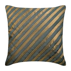 a blue and gold striped pillow on a white background