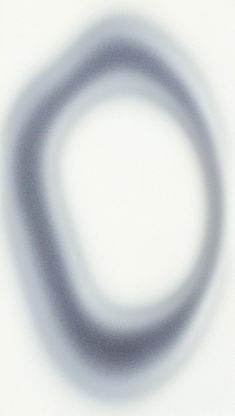 a blurry image of a circular object on a white surface with blue and gray colors