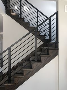 a black and white stair case next to a wall