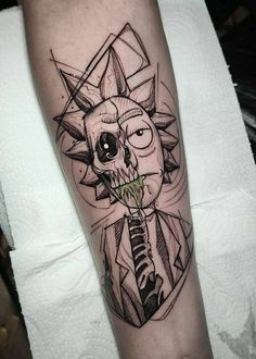 a man's arm with a black and white tattoo on it, depicting a skull holding a knife