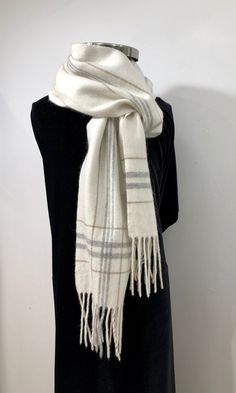 "Vintage - A soft, creamy white \"wooly\" scarf with muted grays and beige stripes along the length and a plaid of the same colors at each end - finished with a 4\" fringe. Cozy, comfortable and elegant - perfect for casual or evening wear * Man made fabric  * unisex  * lightweight * hand wash with cool water item # vsw 43 Please note: ALL my scarves have been carefully hand washed with mild soap, cool water & air dried for a pristine clean freshness and are in excellent condition." Cozy White Winter Scarves, White Cozy Scarves For Fall, Cozy White Scarves For Fall, Cozy White Scarf For Fall, Elegant White Winter Scarf, Checkered Scarf, Beige Scarf, White Scarf, White Scarves