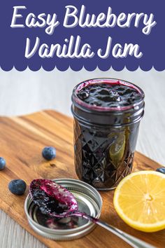 an easy blueberry vanilla jam with lemon slices on a cutting board next to it