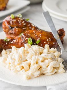 chicken wings and macaroni salad on a plate