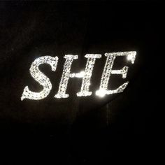 the word she is lit up in white light