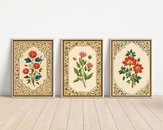 three framed floral paintings on a wall in an empty room with wood flooring and white walls