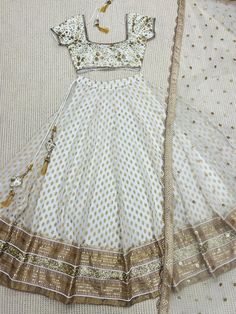 Ivory Designer Fully Customised Lehenga Choli Specification Lehenga Lehenga Fabric : Banarasi Gerogette silk Lehenga Closer: Drawstring, Attached Tussle  Flair: 3.5 Meter Inner: Cotton Skirt Style: Customized  Blouse Blouse Fabric: Raw Silk Blouse Work: Sequins, Kasab, Zardosi Blouse Neck: Fully Customized  Dupatta Dupatta Finish Type: Heavy Lace, Sequins, Kasab, Zardosi Dupatta Fabric: Soft Net Package Contain: Lehenga, Blouse and Dupatta, Drawstring, Tussle  Our products are 100% authentic and White Bollywood Style Traditional Drape Dress, Bollywood Style White Dress For Reception, White Bollywood Dress For Reception, White Organza Floor-length Dress, White Floor-length Dresses With Cutdana, Wedding Saree With Pearl Embroidery For Festivals, Semi-stitched White Dress With Cutdana Details, Semi-stitched White Dress With Cutdana, White Dress For Navratri With Traditional Drape