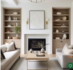 a living room filled with furniture and a fire place in front of a white fireplace