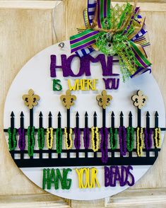 a sign that says home is where you hang your bands on the front door to celebrate st patrick's day