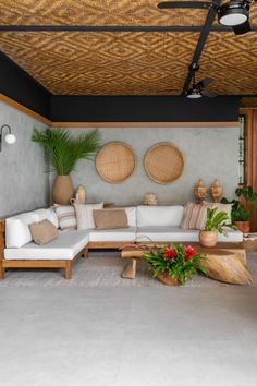 a living room filled with furniture and plants