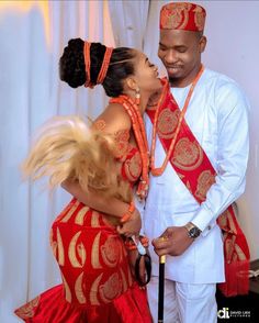 a man and woman dressed in traditional african clothing