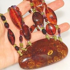 Necklace Stone(s): 3 strands top grade authentic Baltic honey amber (pendant amber measures 3 x 1.5 inches) with authentic amethyst and authentic peridot Necklace Length: 20 inches Deep: 1.5 inches Weight: 80.7 grams Clasp: Toggle Stamp/Mark: N/A Serial Number: n1247 Amber, an organic gemstone, is the fossilized sap of prehistoric trees which grew up to 50 million years ago. The stone has been used for jewelry since the time of Christ. The world's finest amber comes from the region around the Ba Prehistoric Trees, Peridot Necklace, Necklace Stone, Amber Pendant, 50 Million, Necklace Length, Stone Necklace, Necklace Lengths, Amber