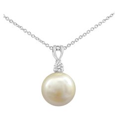 A beautiful pearl necklace, showcasing a 12 mm south sea pearl of golden color. Accented by a single round cut diamond weighing 0.16 carat. Suspended on an adjustable white gold chain, 18 inches in length.   Roman Malakov is a custom house, specializing in creating anything you can imagine. If you would like to receive a special quote on a custom piece, please message or call us. Round Diamond Pendant, Beautiful Pearl Necklace, Round Pendant Necklace, White Gold Chains, Sea Pearl, Sea Pearls, South Sea Pearls, Pearl Pendant Necklace, Lovely Jewellery