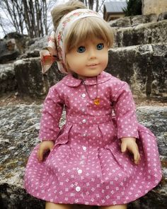 a doll is sitting on some rocks