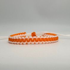 White/Orange cord Bracelet, White/Orange bracelet, Reversible , Lucky Bracelet, Yoga Bracelet, Surfer Bracelet [White/Orange 115] This bracelet is make with Chinese Knotting Cord about 1.5mm thin cord.  This Bracelet is reversible. The Bracelet is adjustable in size, 6 inches closed to 12 1/2 inches.  Color: White / Orange Feel free to contact me for any question!! *Color may slightly different due to the lighting!! ** This is HANDMADE item, the color of pattern, shape might be little different Chinese Knotting Cord, Chinese Knotting, Orange Bracelet, Surfer Bracelets, Lucky Bracelet, Chinese Knot, Yoga Bracelet, Cord Bracelet, Cord Bracelets