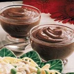 two glasses of chocolate pudding on a plate