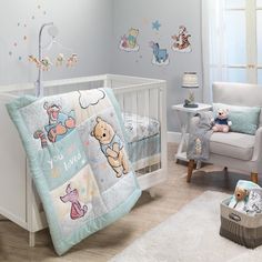 a baby's room with a crib, rocking chair and teddy bear bedding