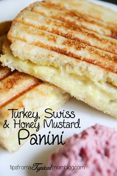 grilled cheese and honey mustard panini on a white plate with pink ice cream