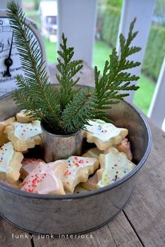 a tin filled with cookies sitting on top of a wooden table