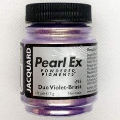 a jar of purple paint sitting on top of a white table