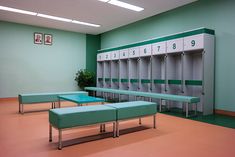 a row of green and white lockers sitting next to each other in a room