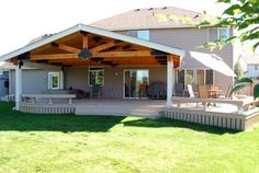 a covered patio in the back yard of a house