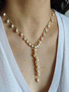 Next day shipping A unique pearl necklace is the best gift for friends and family. This 14k gold-filled pearl necklace is handcrafted from natural freshwater pearls and cable gold chains. Unique, generous, and elegant, it can be matched with different types of fashion. Pearls are in the shape of rice grains. The string of pearls and pendants is made up of many pearls strung into the shape of ears of wheat, which symbolizes good luck and good harvest. Pearl White Lariat Necklace Gift, Pearl White Lariat Necklace As Gift, White Lariat Necklace Gift, White Pearl Charm Lariat Necklace Gift, White Lariat Necklace With Pearl Charm As Gift, White Lariat Drop Necklace For Gift, White Pearl Dangle Necklace With Clavicle Chain, White Pearl Necklace With Clavicle Chain And Dangle, White Pearl Lariat Necklace Gift