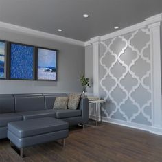 a living room with grey couches and two paintings on the wall behind them, along with hardwood flooring