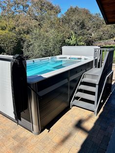 an outdoor hot tub with stairs leading up to it