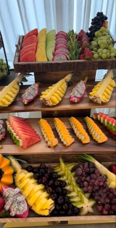 various types of fruit displayed on wooden trays