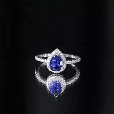 two pear shaped blue and white diamond rings